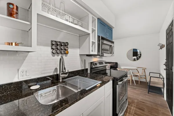 a kitchen with a sink stove and cabinets