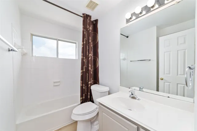a bathroom with a sink toilet tub and shower