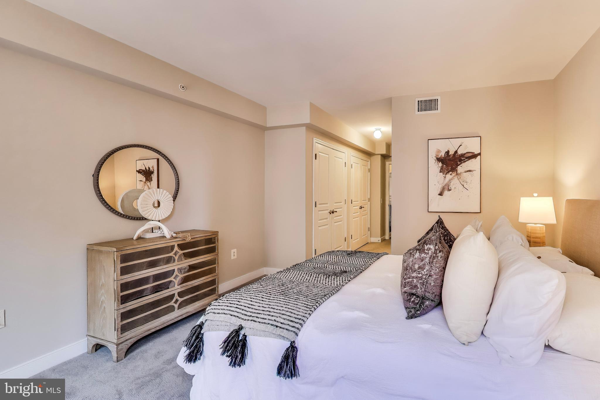616 E Street Northwest, Unit 648 Washington, DC 20004 - Photo 12 of 39 a bedroom with a bed and a chandelier