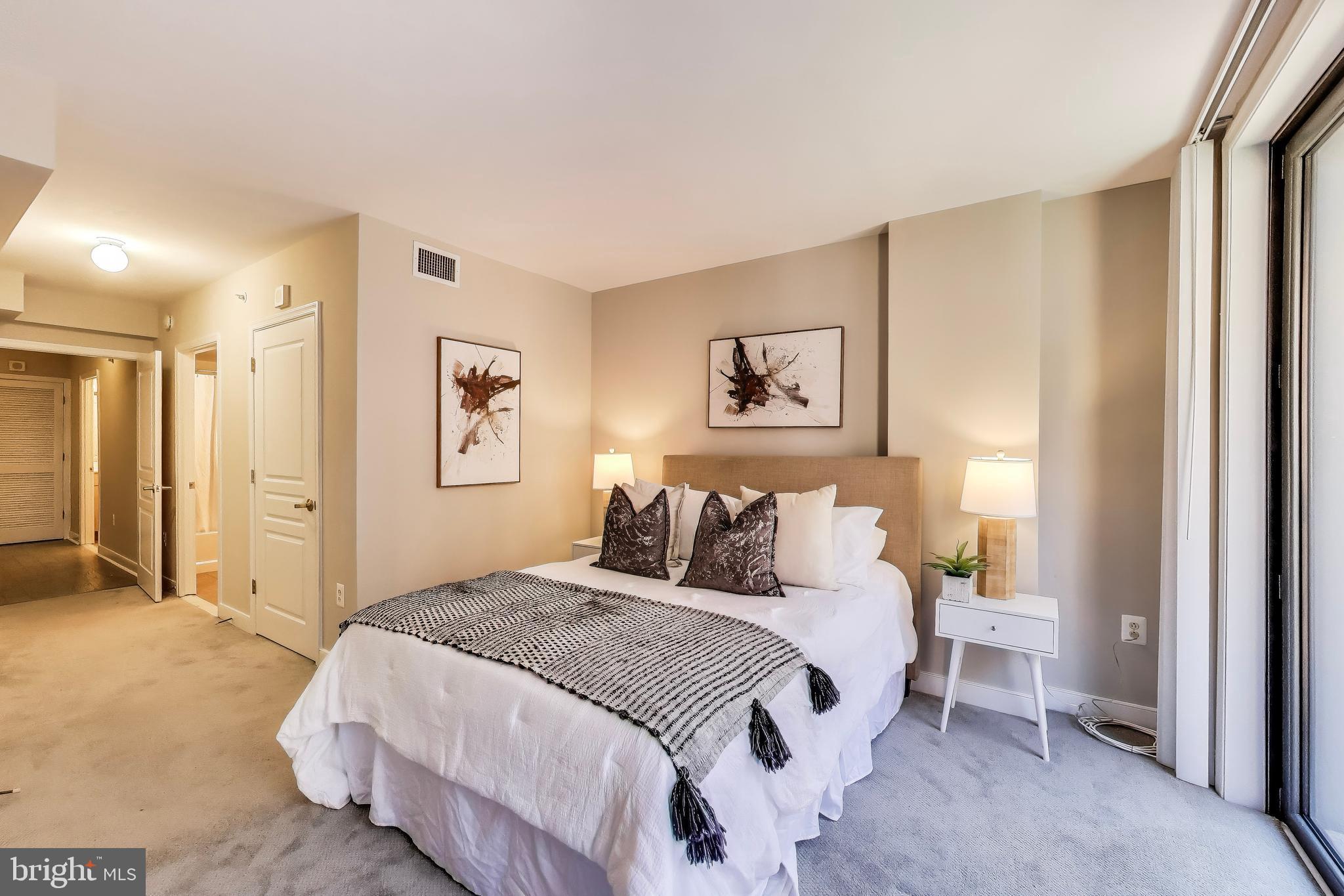 616 E Street Northwest, Unit 648 Washington, DC 20004 - Photo 13 of 39 a bedroom with a bed and painting on the wall