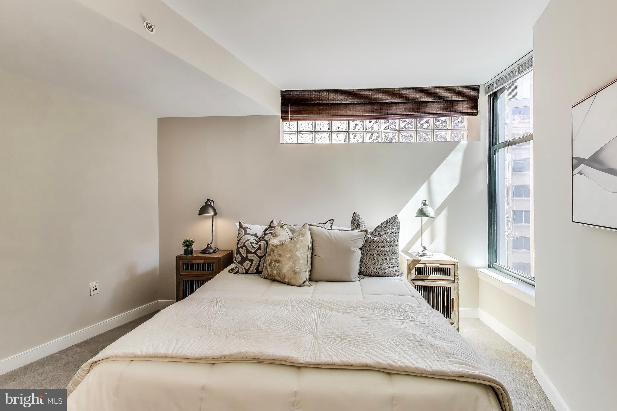 616 E Street Northwest, Unit 648 Washington, DC 20004 - Photo 16 of 39 a bedroom with a bed and a window