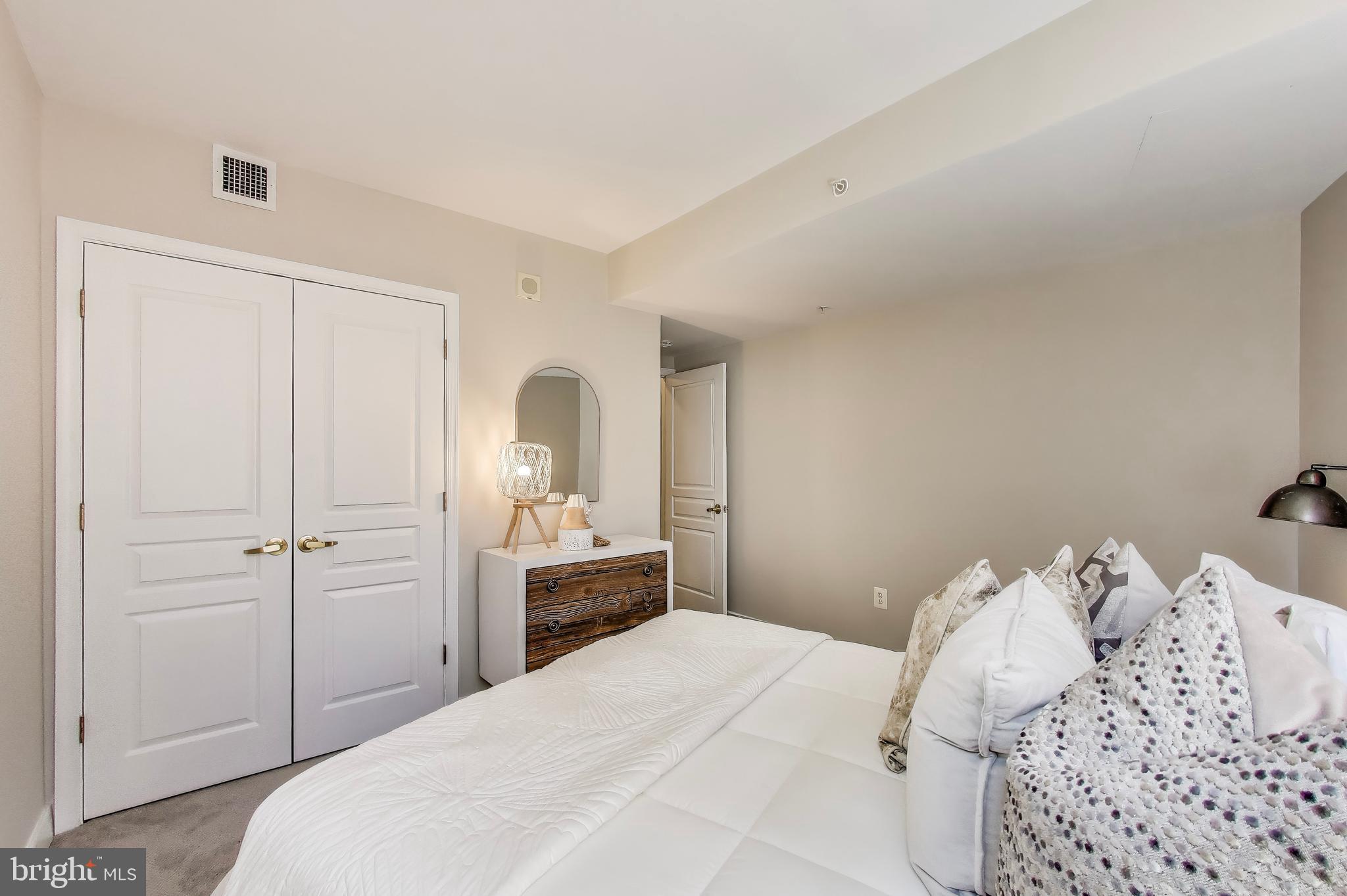 616 E Street Northwest, Unit 648 Washington, DC 20004 - Photo 17 of 39 a bedroom with a bed and a closet