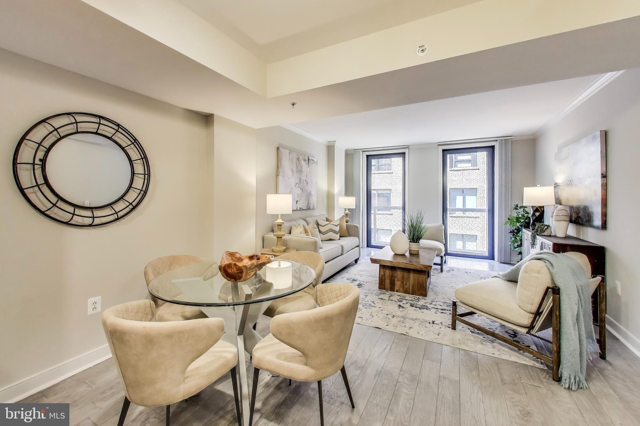 616 E Street Northwest, Unit 648 Washington, DC 20004 - Photo 2 of 39 a living room with furniture a window and a dining table