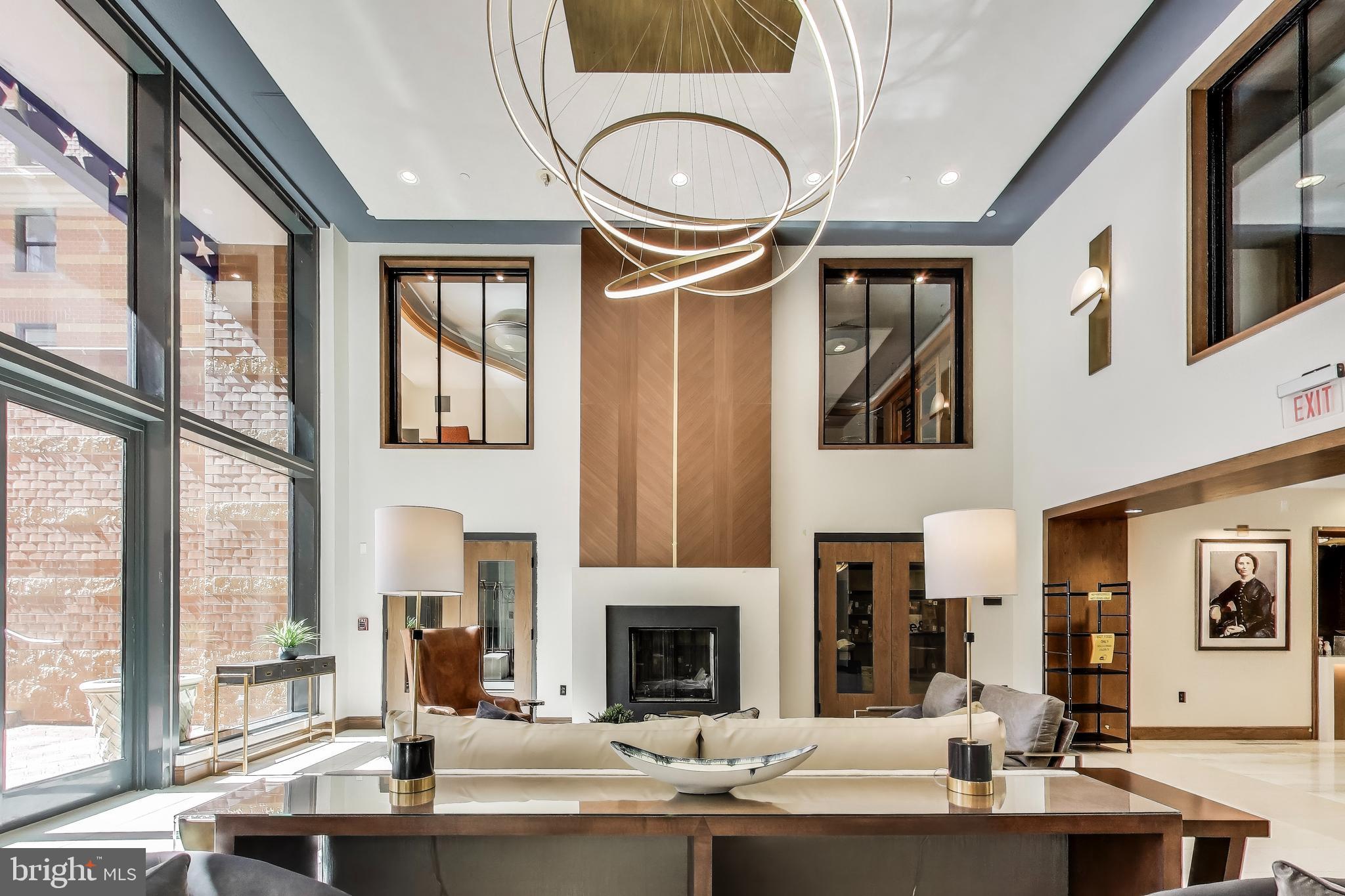 616 E Street Northwest, Unit 648 Washington, DC 20004 - Photo 21 of 39 a view of living room kitchen with furniture and large windows
