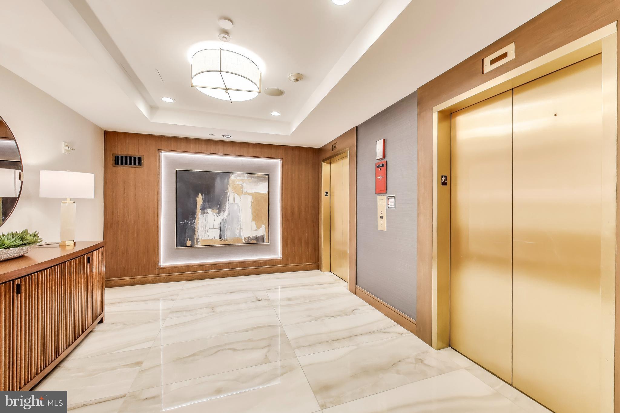616 E Street Northwest, Unit 648 Washington, DC 20004 - Photo 22 of 39 a view of a hallway to a bedroom with a chandelier