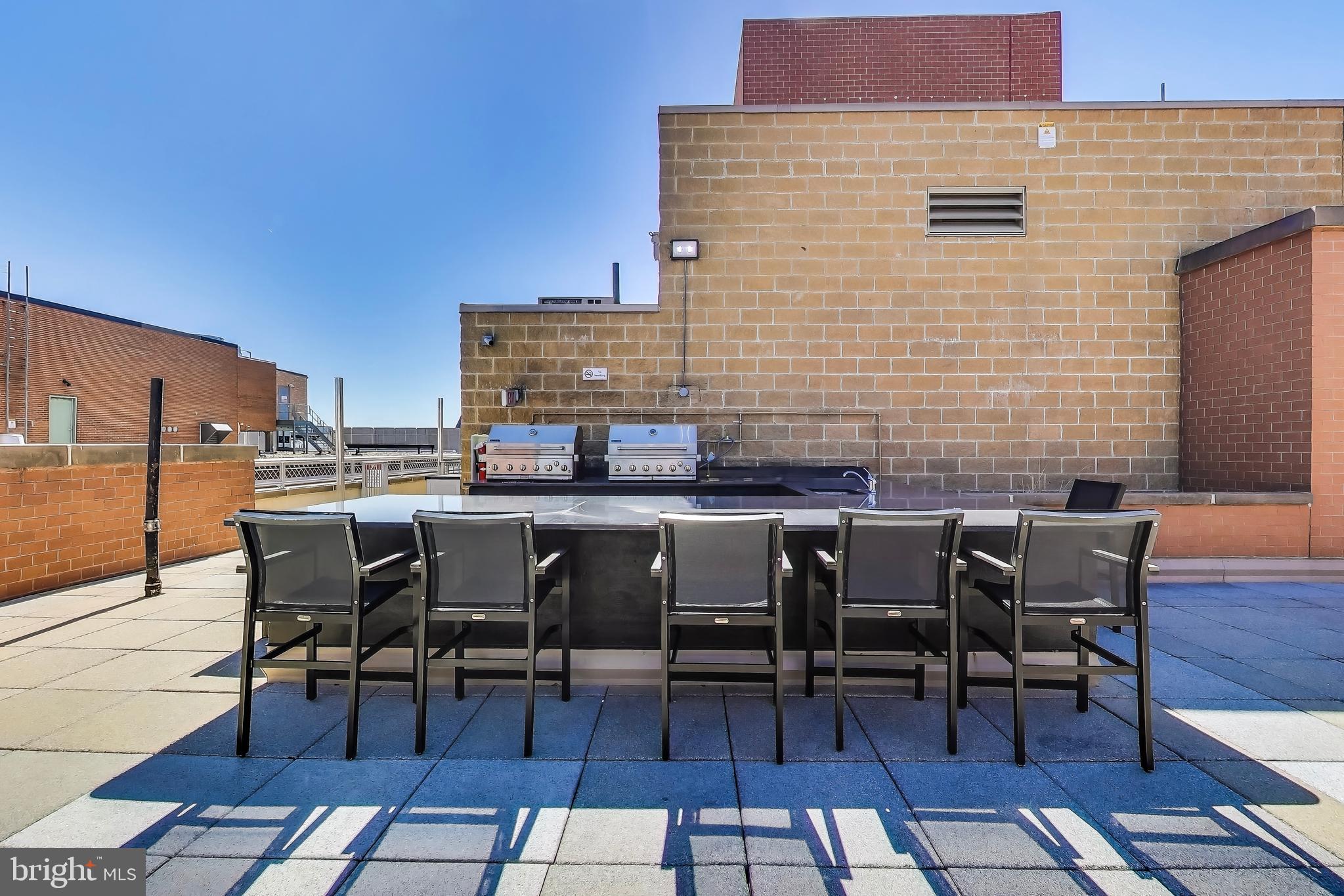 616 E Street Northwest, Unit 648 Washington, DC 20004 - Photo 27 of 39 a view of a patio with table and chairs and floor to ceiling window
