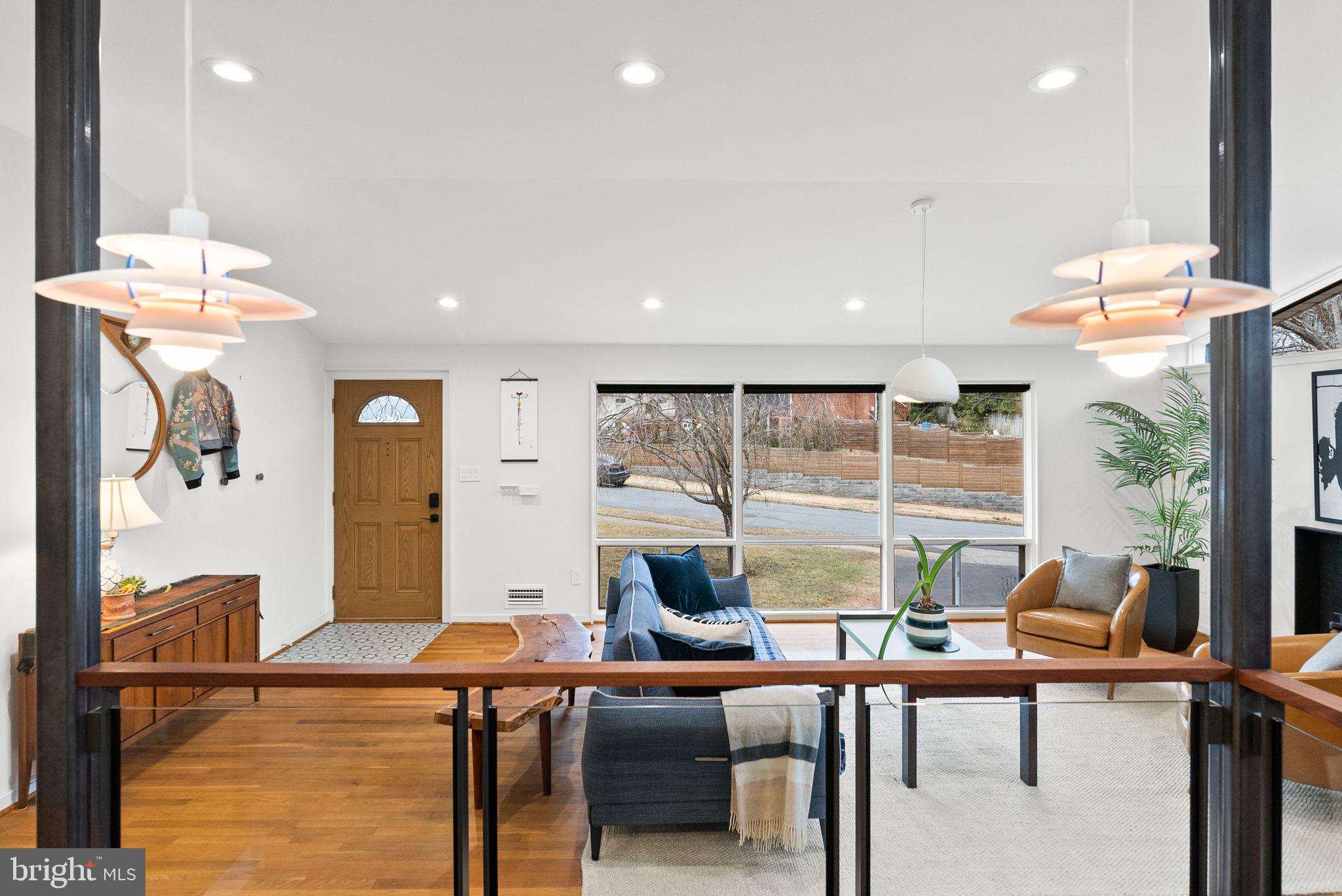7405 Add Drive Falls Church, VA 22042 - Photo 17 of 74 a living room with furniture a large window and a chandelier