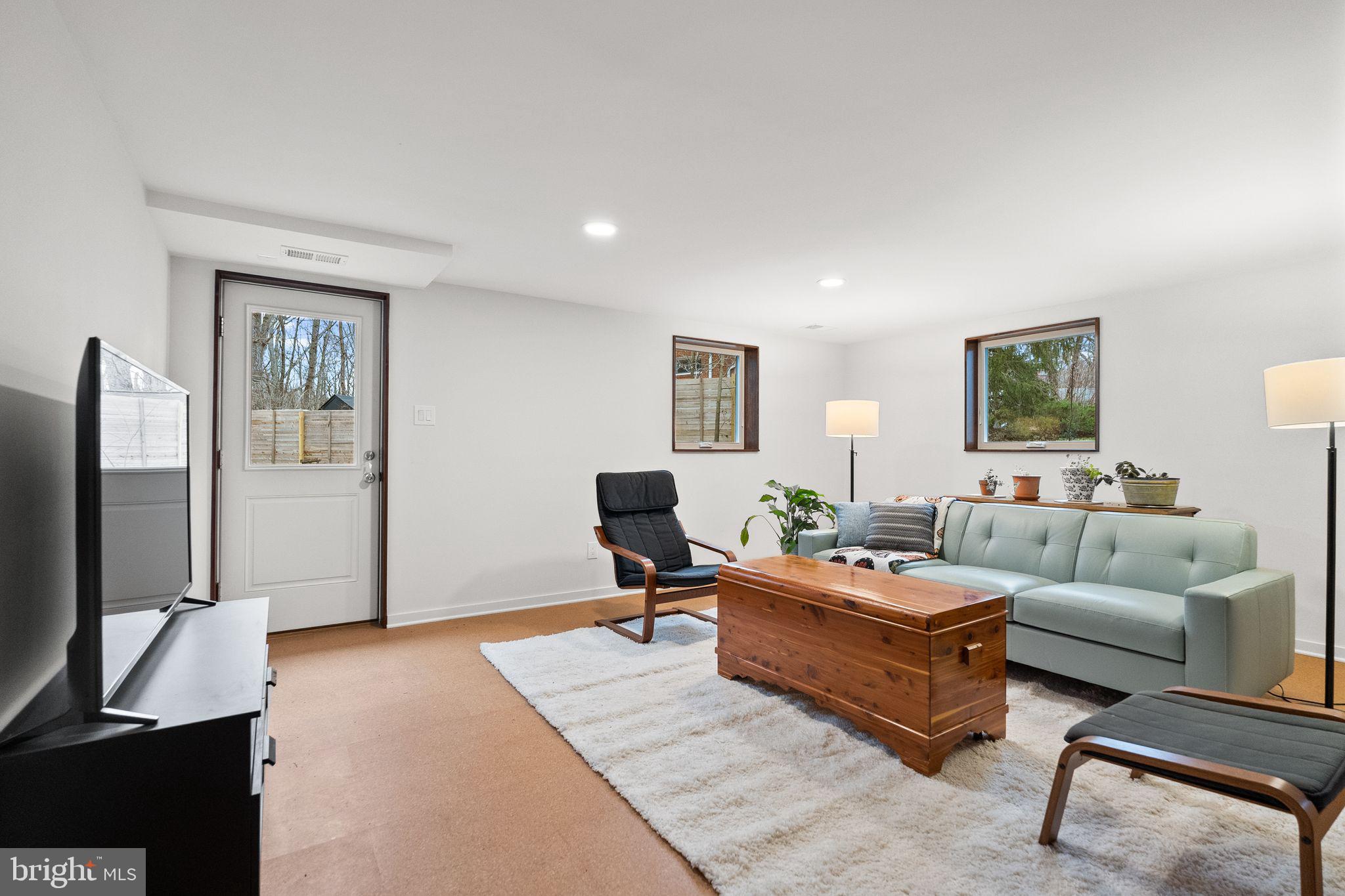 7405 Add Drive Falls Church, VA 22042 - Photo 33 of 74 a living room with furniture wooden floor and a flat screen tv
