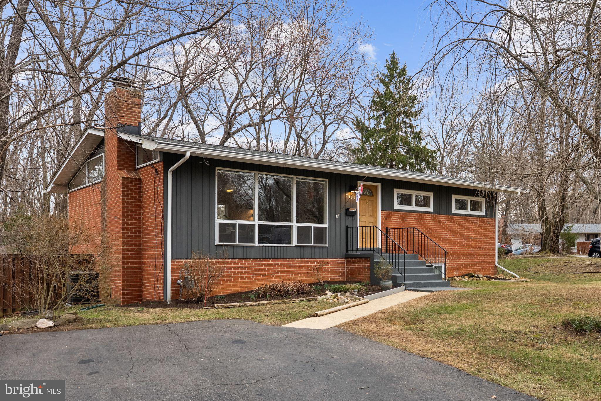 7405 Add Drive Falls Church, VA 22042 - Photo 70 of 74 a front view of a house with a yard and garage