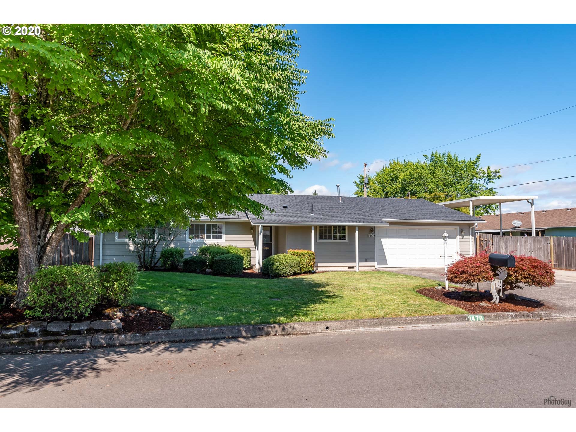 2470 North 14th Place Springfield, OR 97477 - Photo 1 of 32 a front view of a house with a yard and a garage