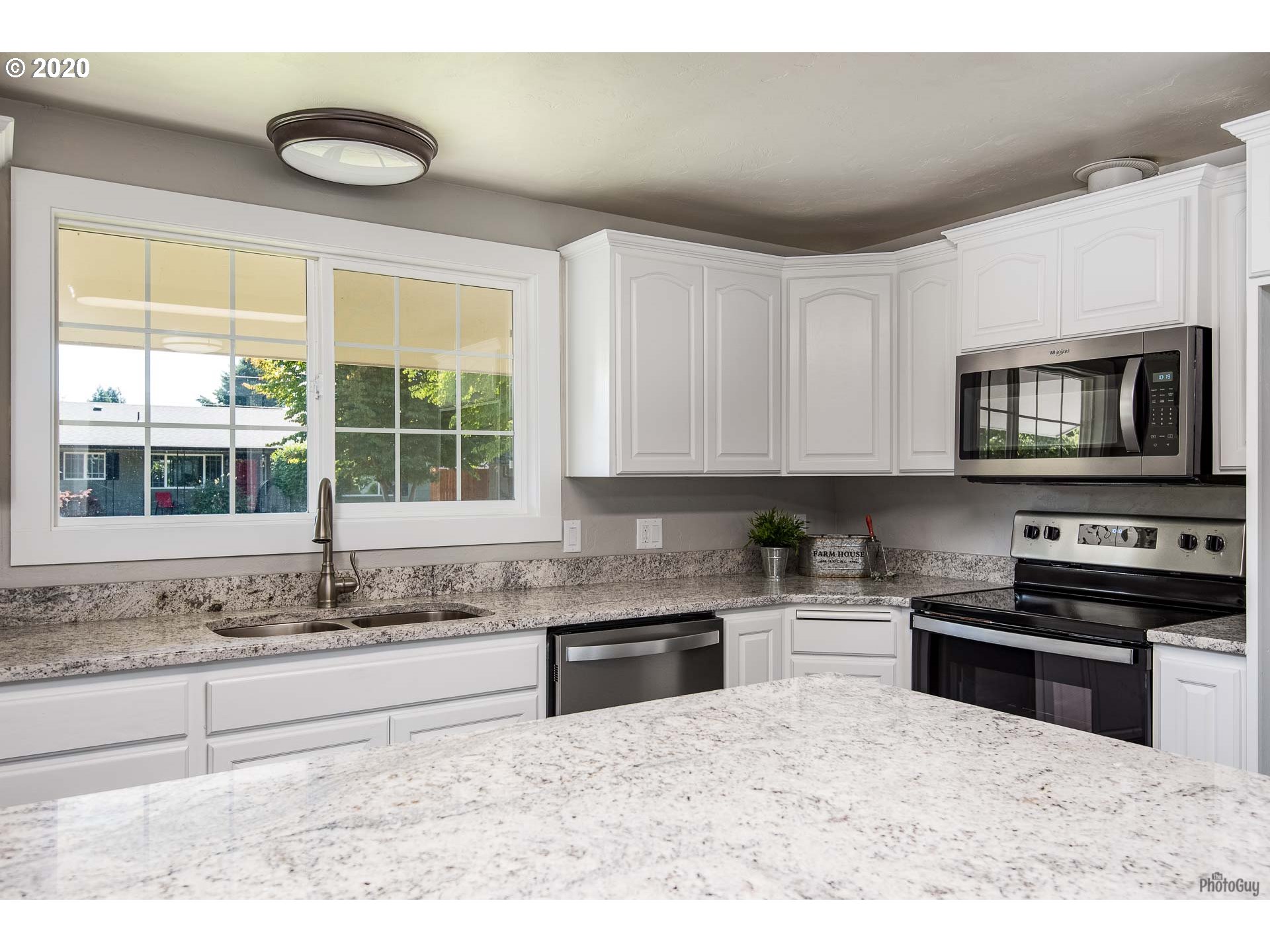 2470 North 14th Place Springfield, OR 97477 - Photo 11 of 32 a kitchen with stainless steel appliances granite countertop a stove a sink and a microwave