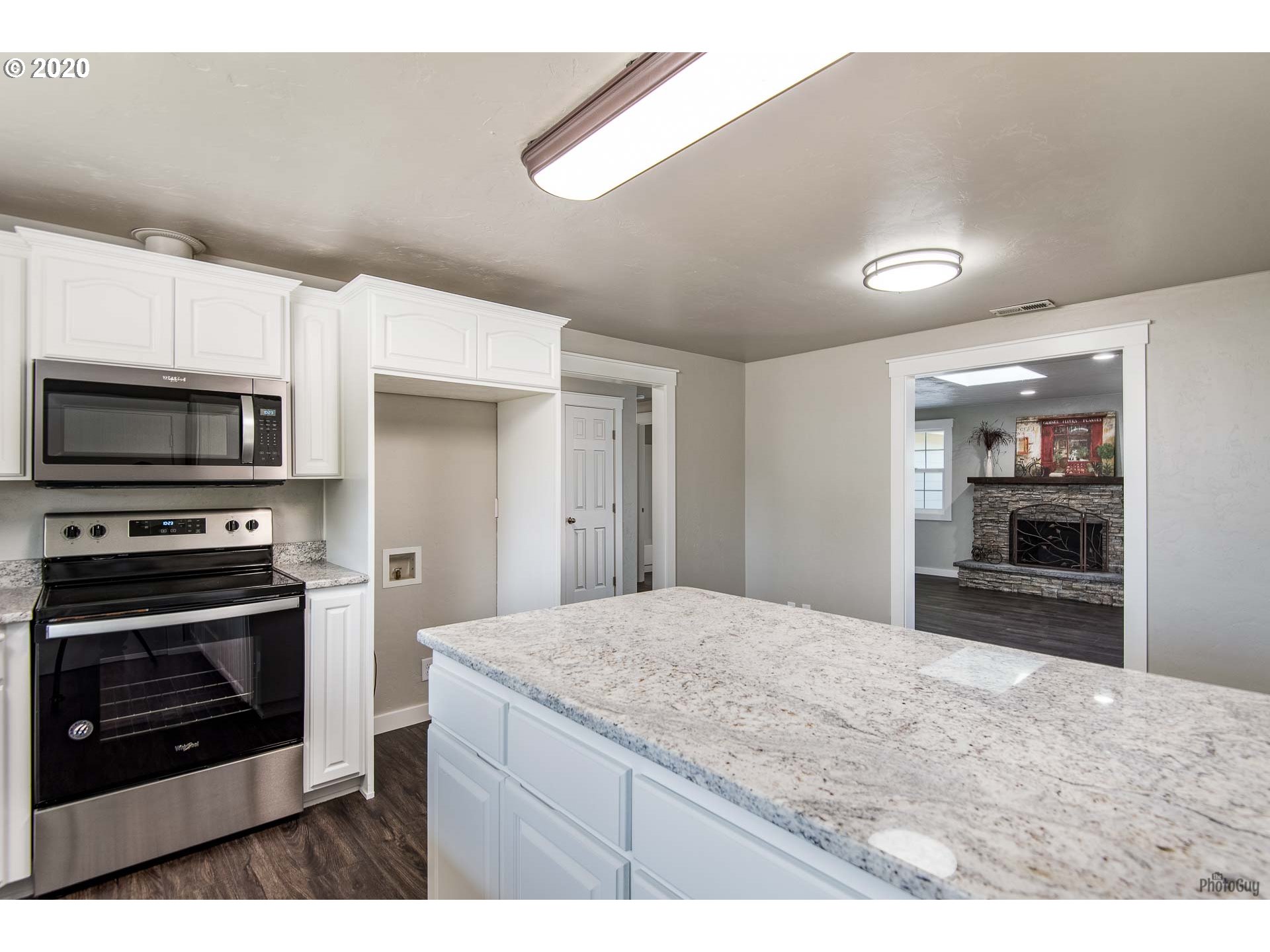2470 North 14th Place Springfield, OR 97477 - Photo 12 of 32 a kitchen with stainless steel appliances kitchen island granite countertop a stove and a sink