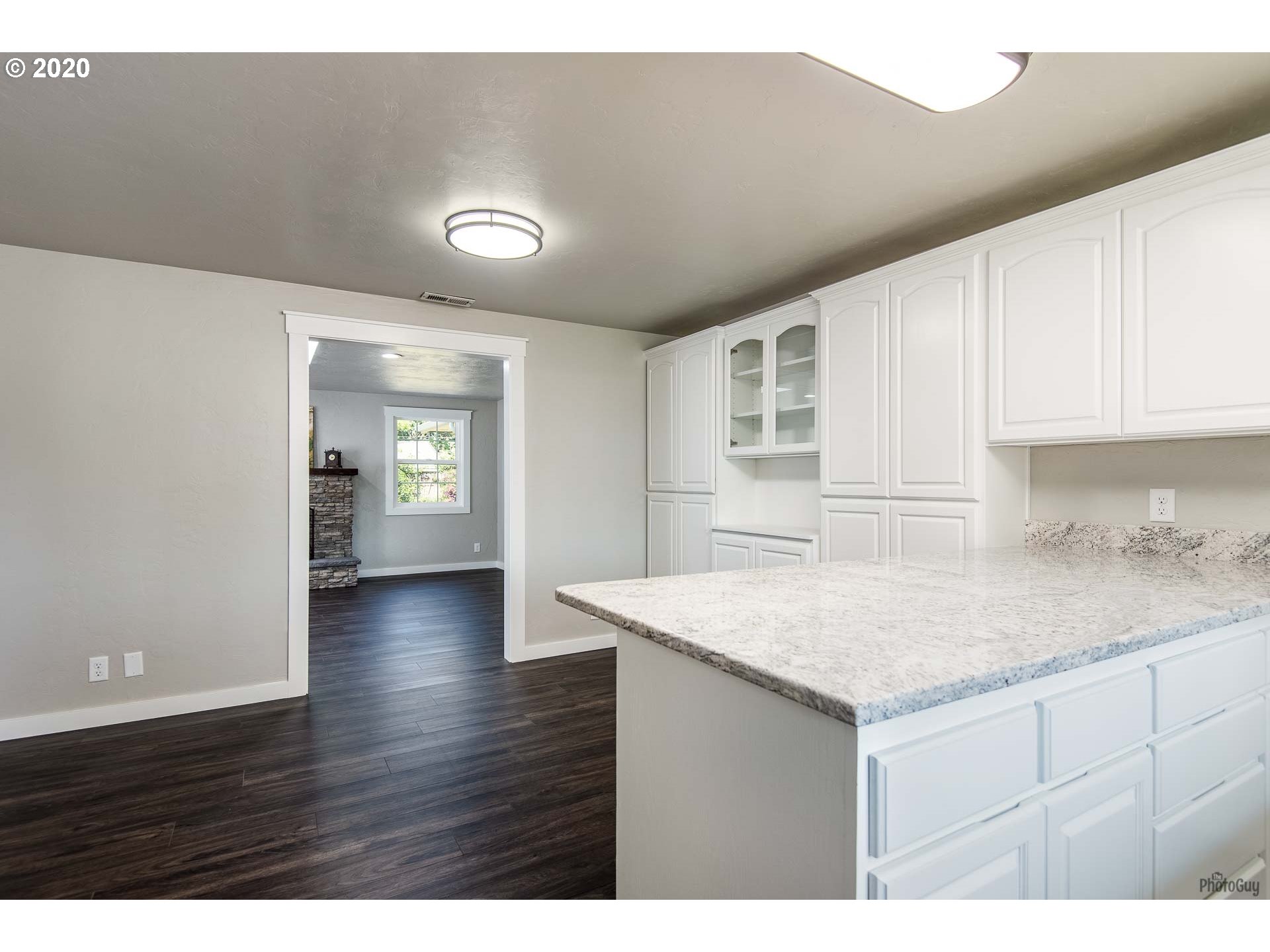 2470 North 14th Place Springfield, OR 97477 - Photo 13 of 32 a view of kitchen with granite countertop cabinets and wooden floor