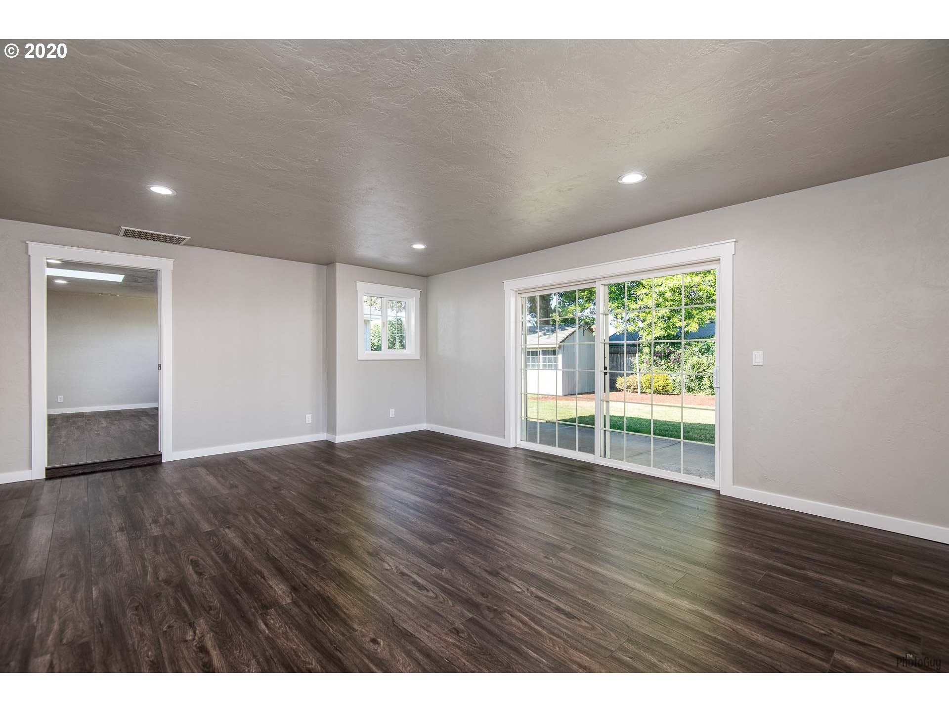 2470 North 14th Place Springfield, OR 97477 - Photo 14 of 32 a view of an empty room with wooden floor and a window