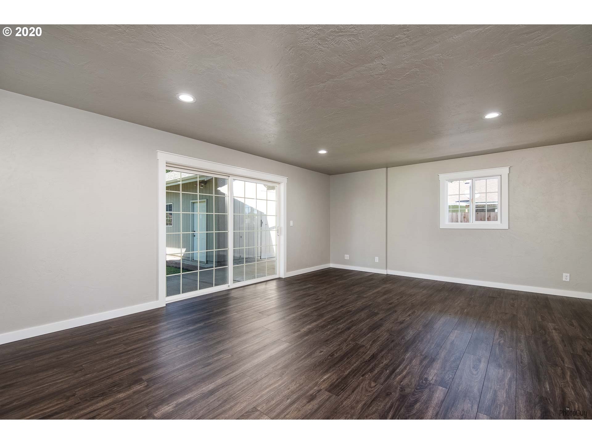 2470 North 14th Place Springfield, OR 97477 - Photo 15 of 32 a view of an empty room with wooden floor and a window