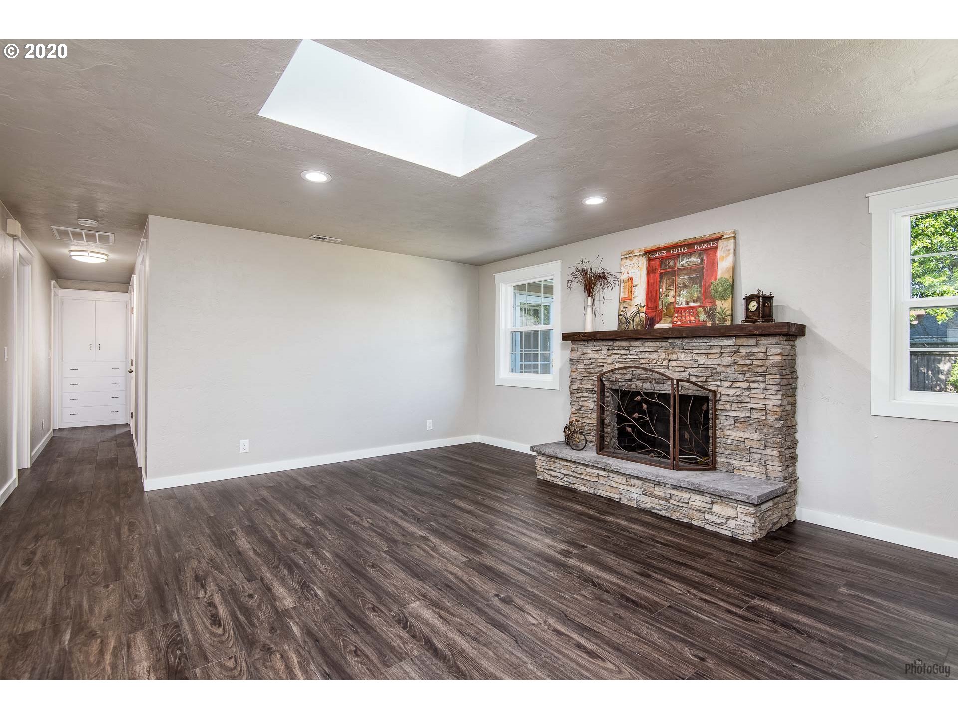 2470 North 14th Place Springfield, OR 97477 - Photo 6 of 32 a view of empty room with wooden floor and fireplace