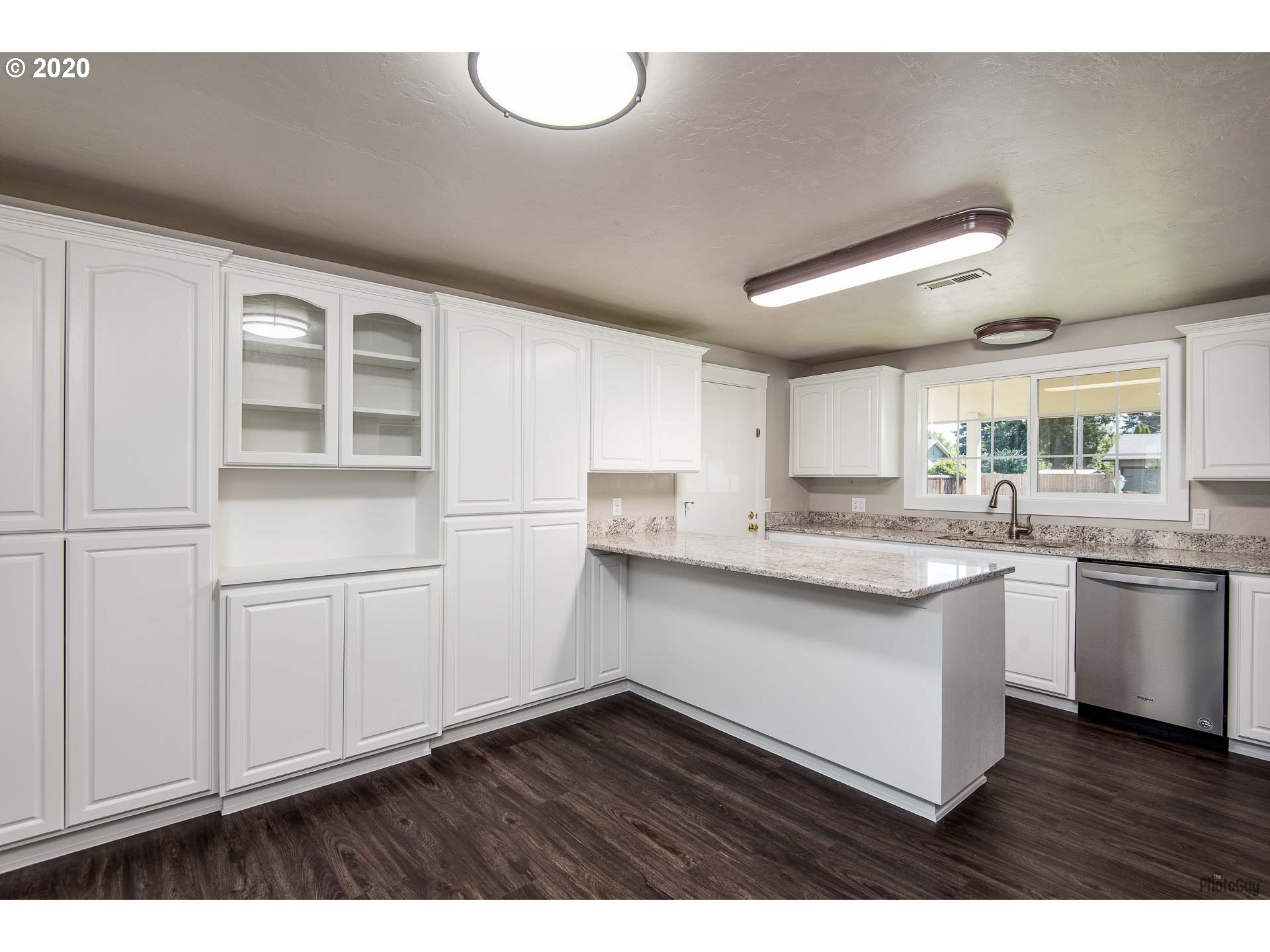 2470 North 14th Place Springfield, OR 97477 - Photo 8 of 32 a kitchen with cabinets and wooden floors