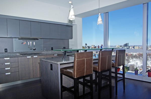 110 Stuart Street, Unit 23G Boston, MA 02116 - Photo 2 of 14 a kitchen with a table chairs stove and cabinets