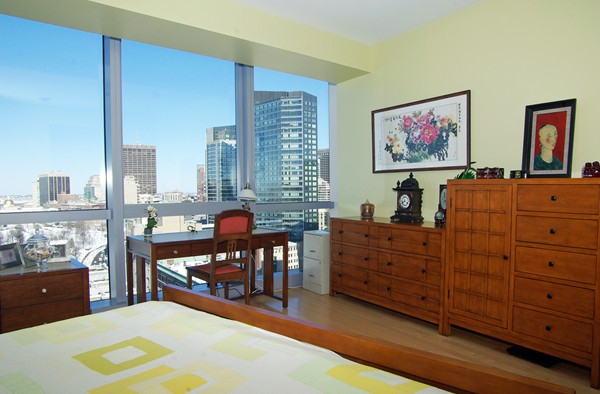 110 Stuart Street, Unit 23G Boston, MA 02116 - Photo 9 of 14 a bed room with furniture and a flat screen tv