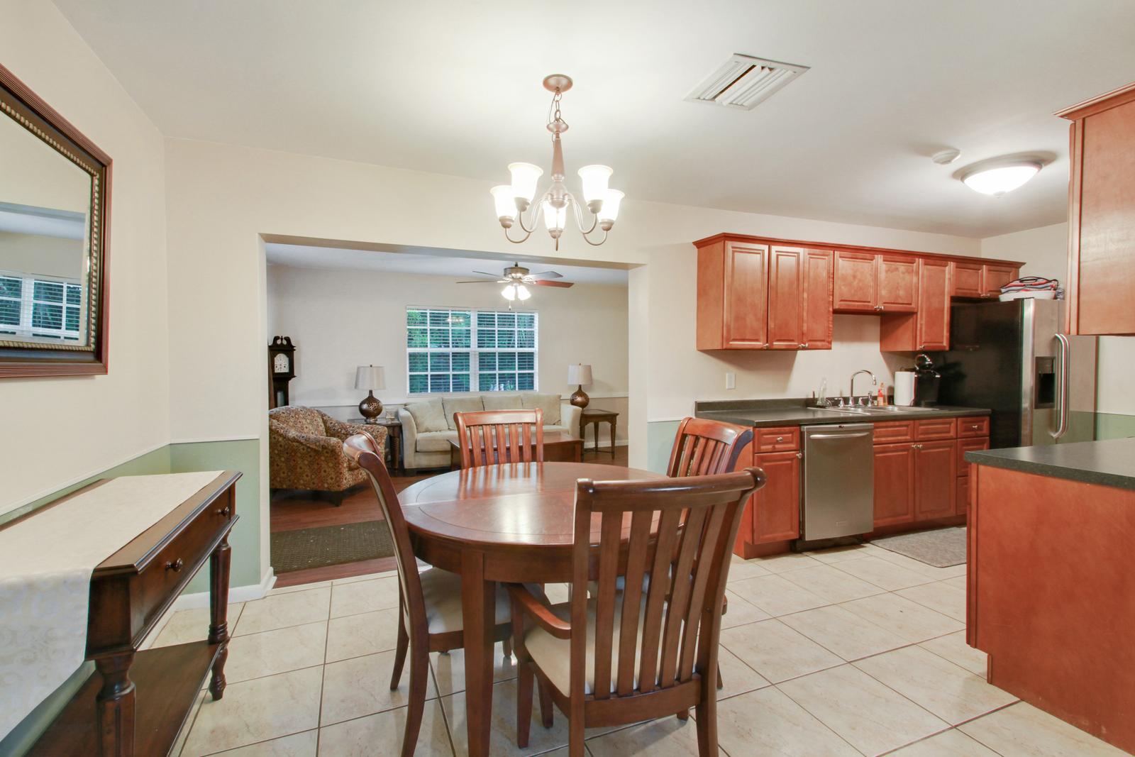 79 Andros Road Palm Springs, FL 33461 - Photo 3 of 11 a view of a dining room with furniture and a chandelier