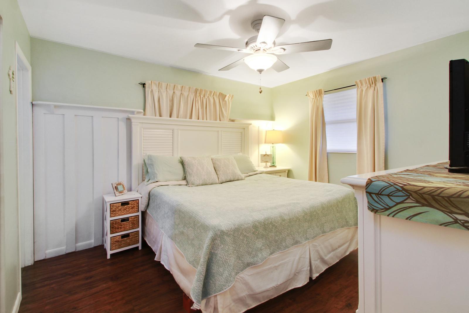 79 Andros Road Palm Springs, FL 33461 - Photo 6 of 11 a bedroom with a bed and a chandelier