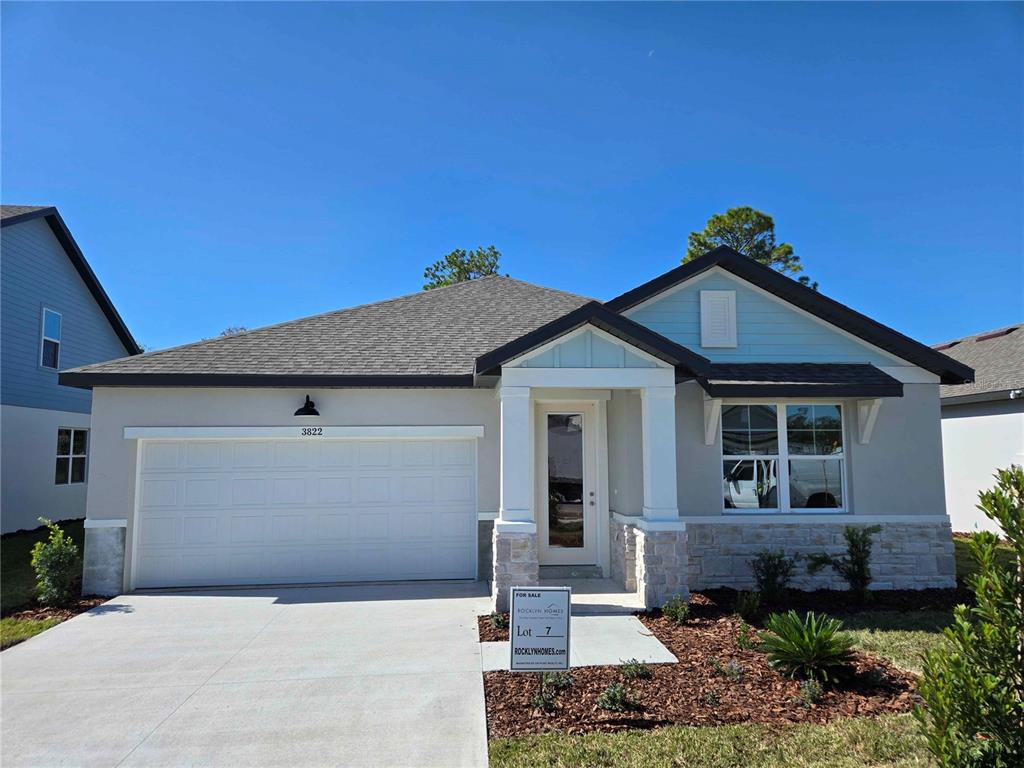 3822 Daybreak Run Loop Spring Hill, FL 34609 - Photo 1 of 13 a front view of a house with garage