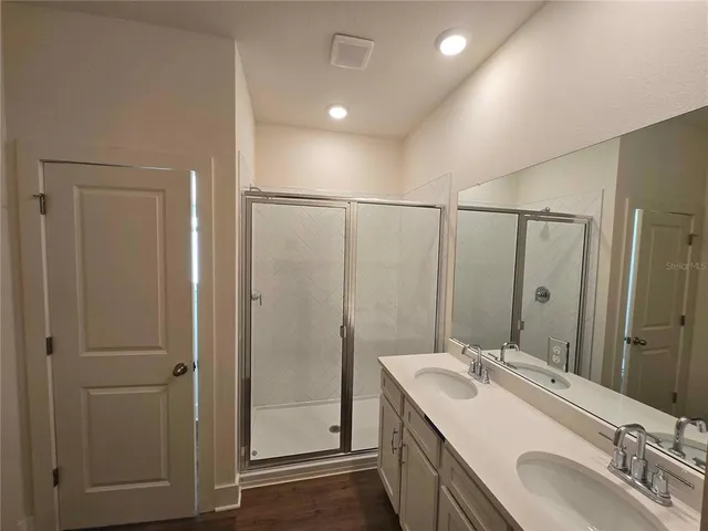 a bathroom with a double vanity sink mirror and double