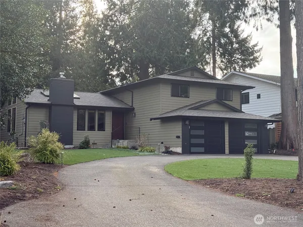 a front view of a house with a yard and a garage