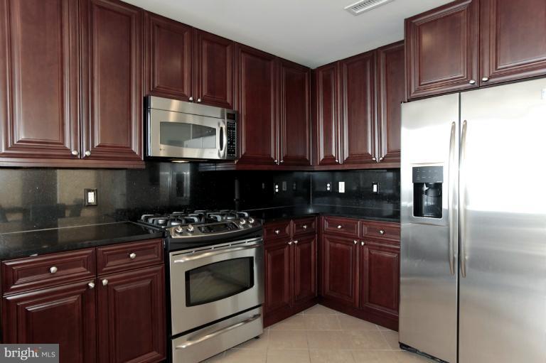 11990 Market Street, Unit 1607 Reston, VA 20190 - Photo 25 of 28 Beautiful cherry cabinets