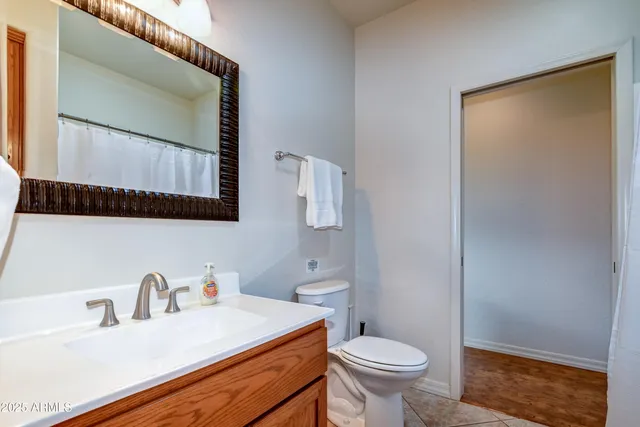a bathroom with a sink toilet and mirror