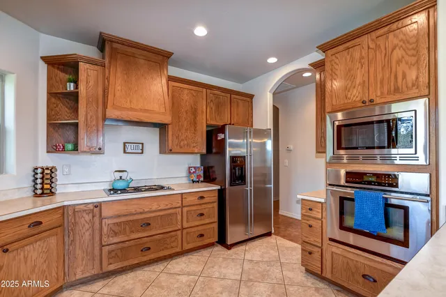 a kitchen with stainless steel appliances a stove microwave and refrigerator