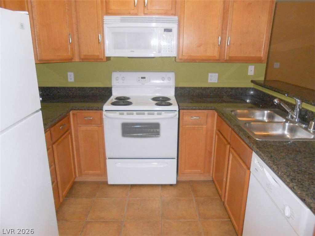 9325 West Desert Inn Road, Unit 132 Las Vegas, NV 89117 - Photo 13 of 36 Functional kitchen with ample cabinet space, durable countertops, and essential appliances.