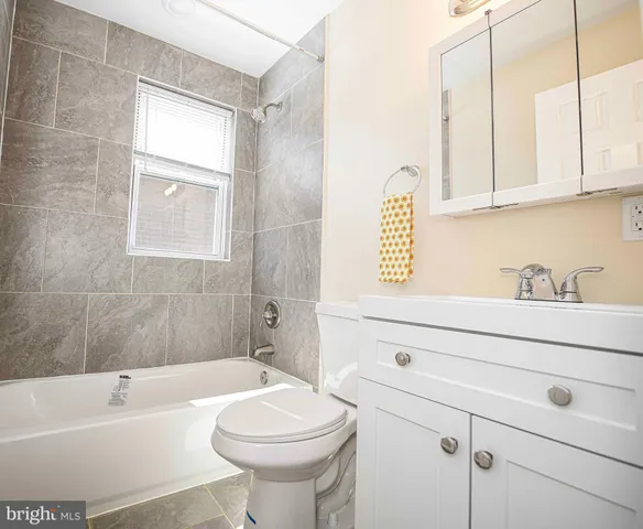 a bathroom with a sink a toilet and bathtub