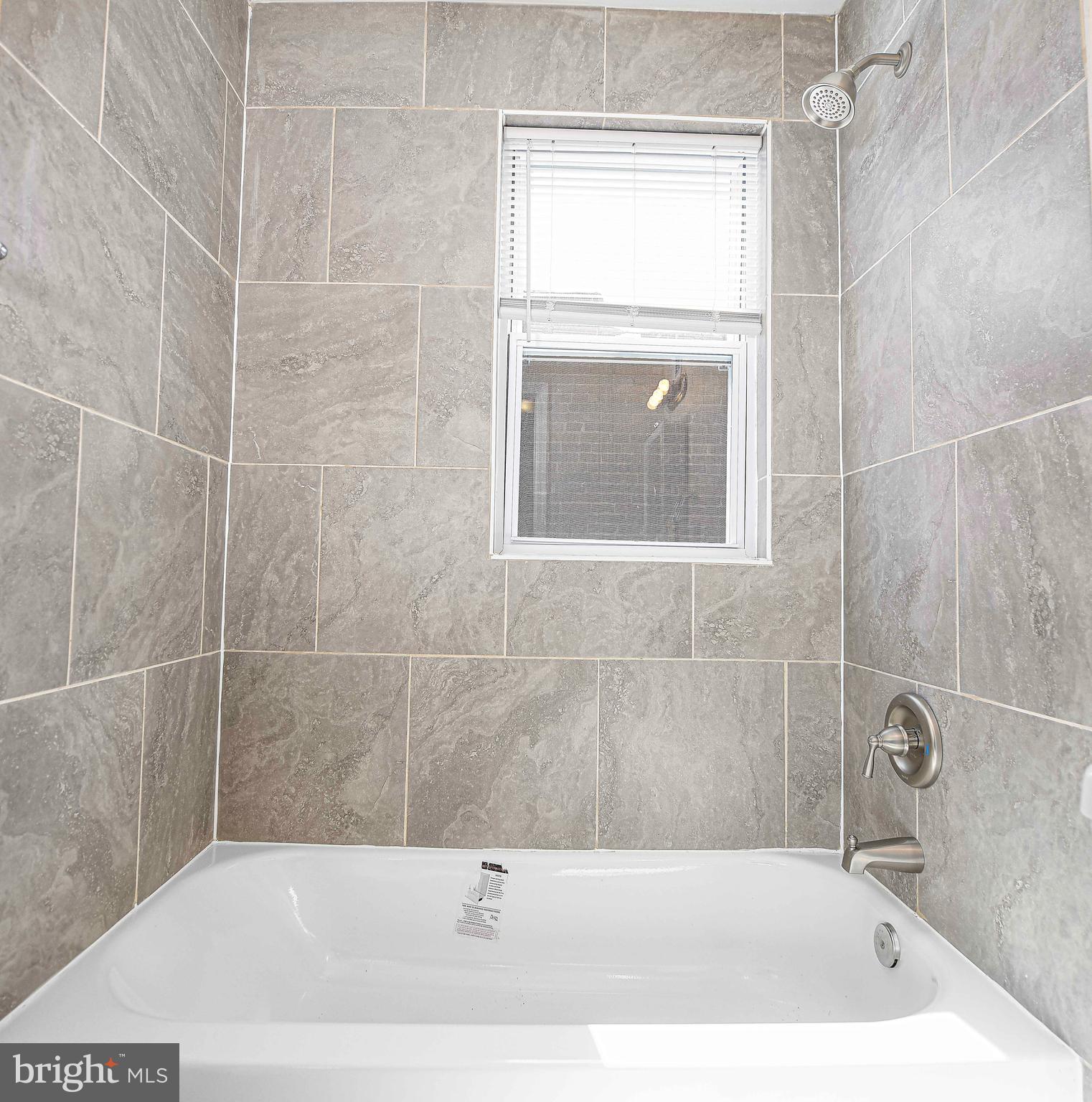 5332 Cuthbert Avenue Baltimore, MD 21215 - Photo 13 of 33 a bathroom with a tub a window and vanity