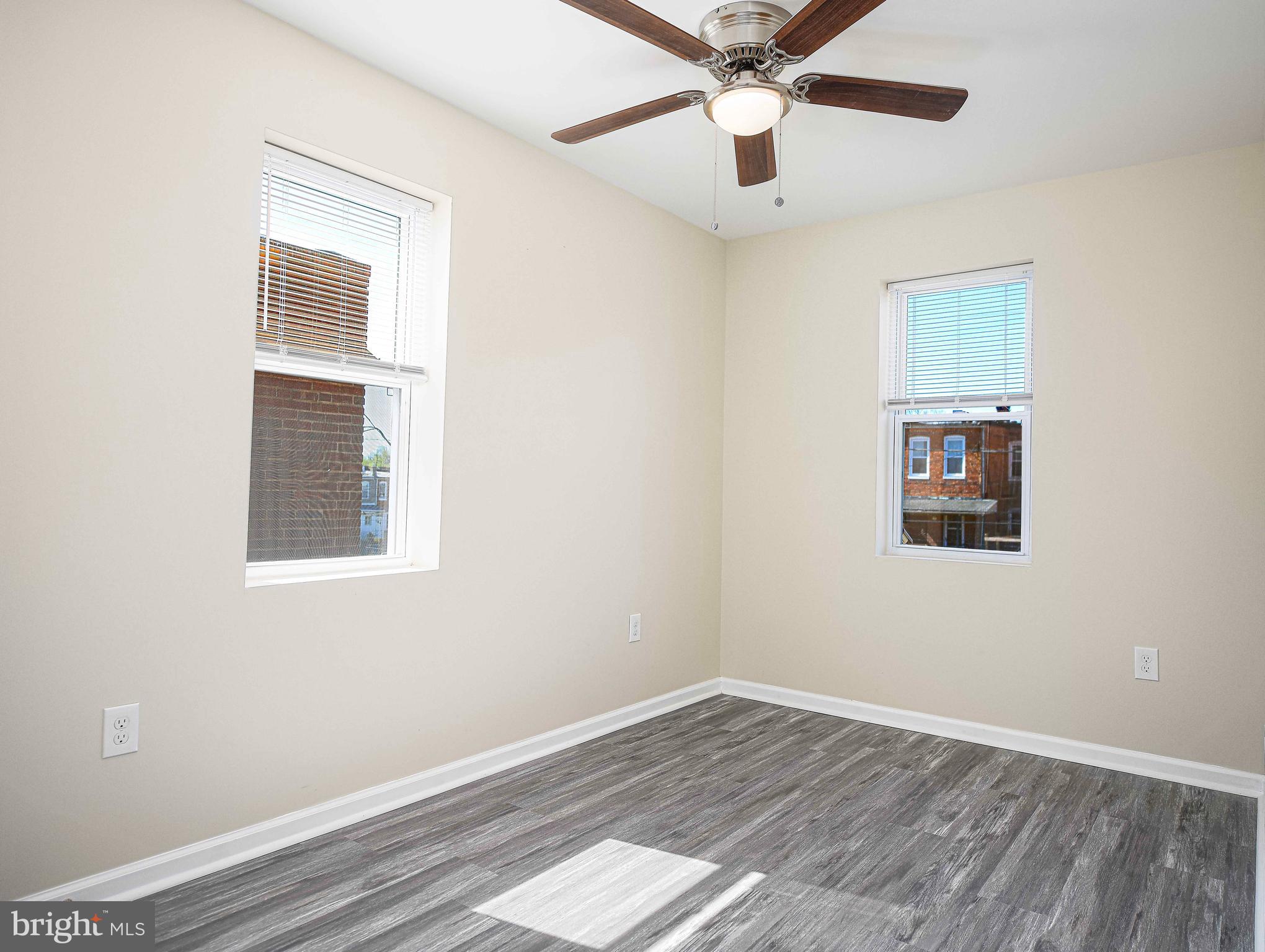5332 Cuthbert Avenue Baltimore, MD 21215 - Photo 15 of 33 a view of an empty room with wooden floor and a window