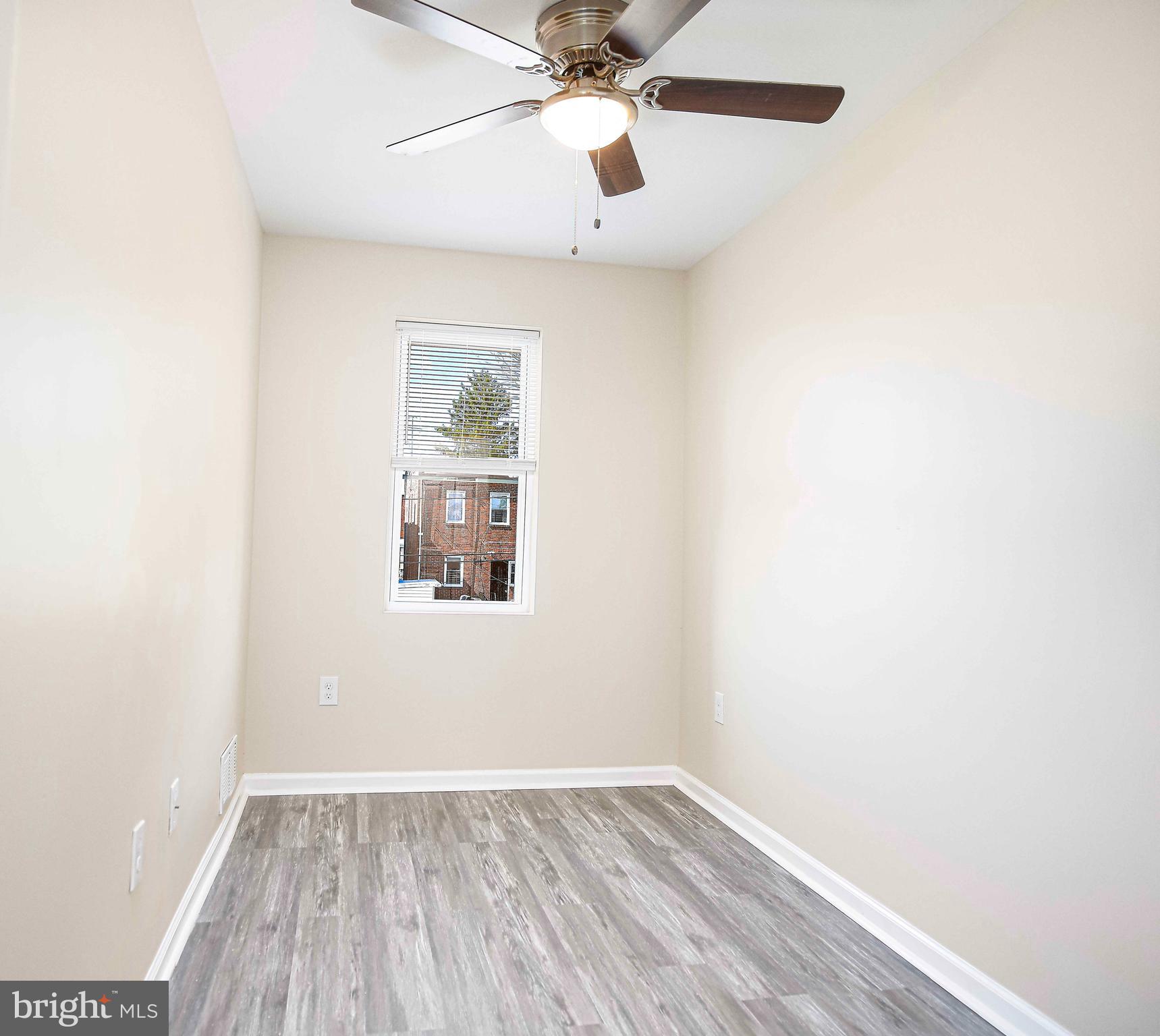 5332 Cuthbert Avenue Baltimore, MD 21215 - Photo 16 of 33 an empty room with a window and a fan