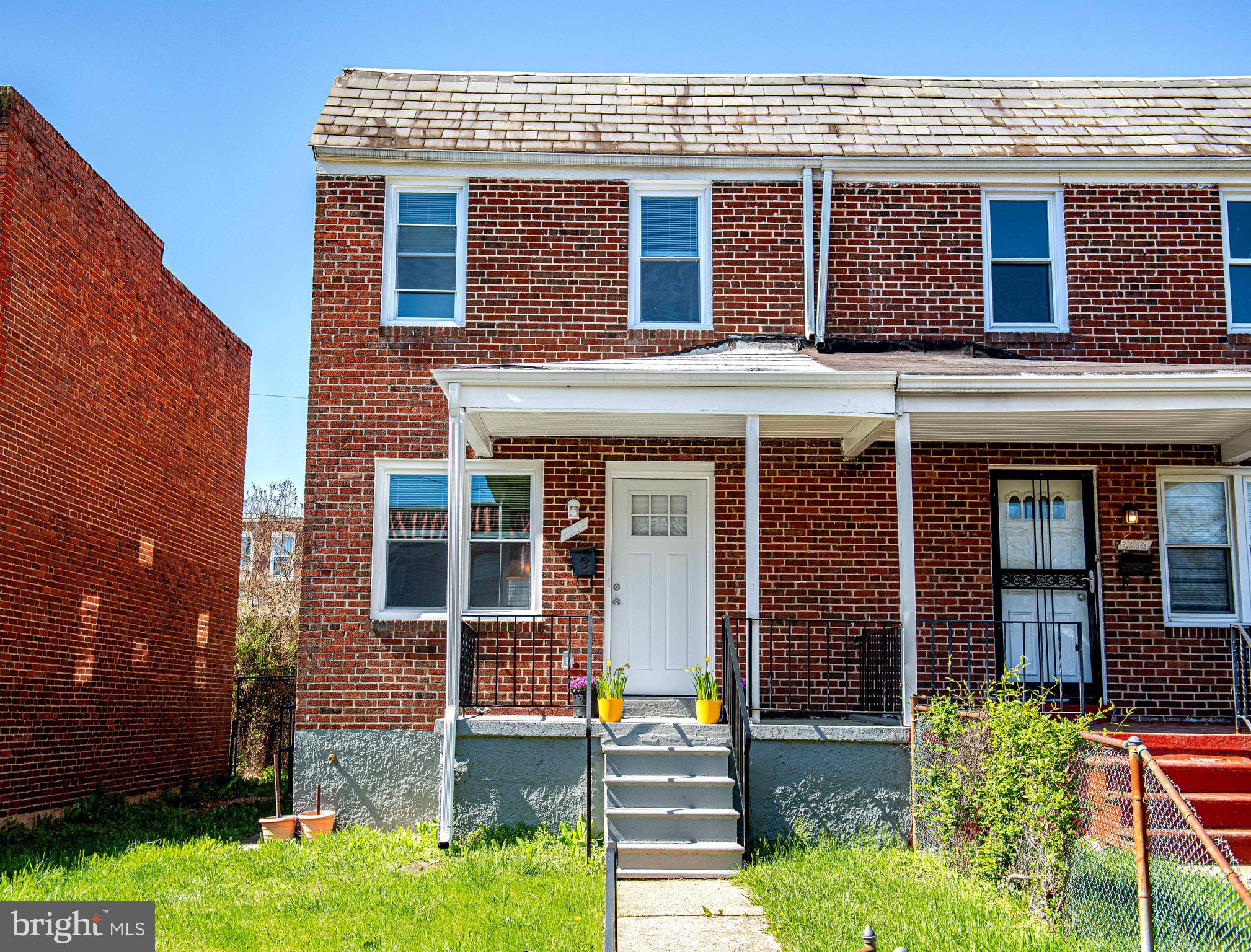 5332 Cuthbert Avenue Baltimore, MD 21215 - Photo 23 of 33 front view of a brick house with a yard