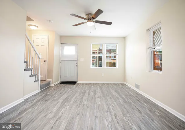 wooden floor in an empty room with a window