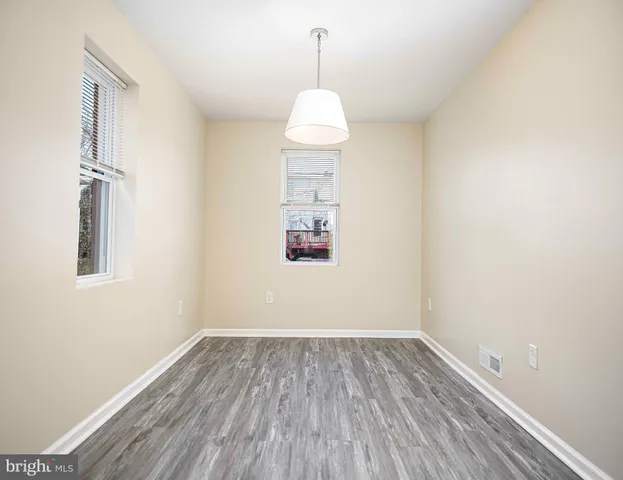 a room that has a window and wooden floor