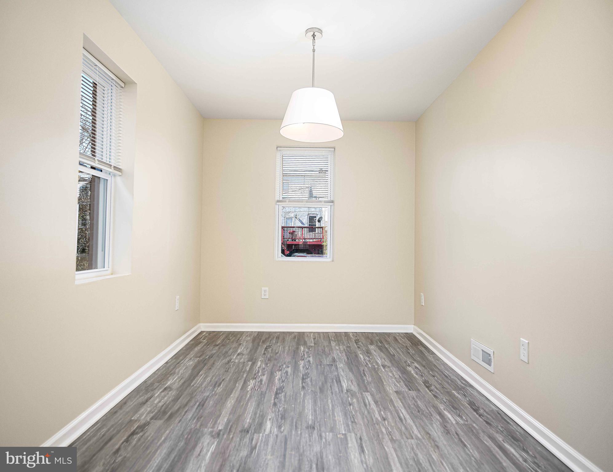 5332 Cuthbert Avenue Baltimore, MD 21215 - Photo 6 of 33 a room that has a window and wooden floor