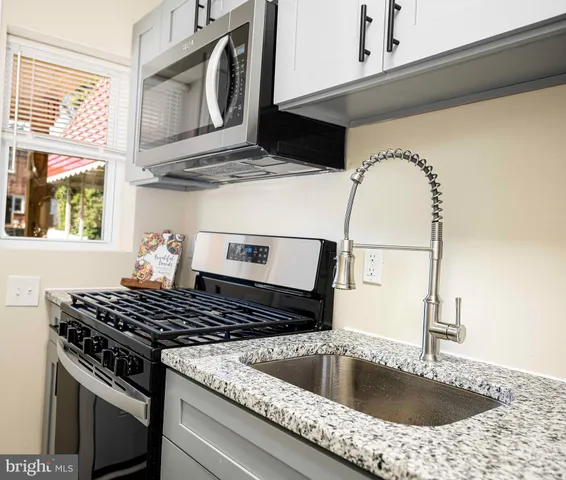 a kitchen with a stove and a sink