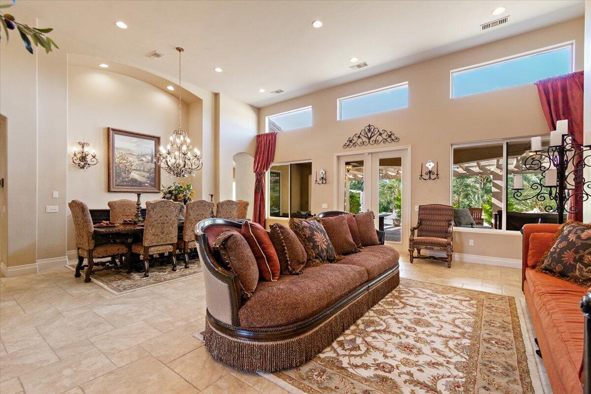 31453 Chimayo Road Thousand Palms, CA 92276 - Photo 12 of 71 a living room with furniture a large window and a fireplace