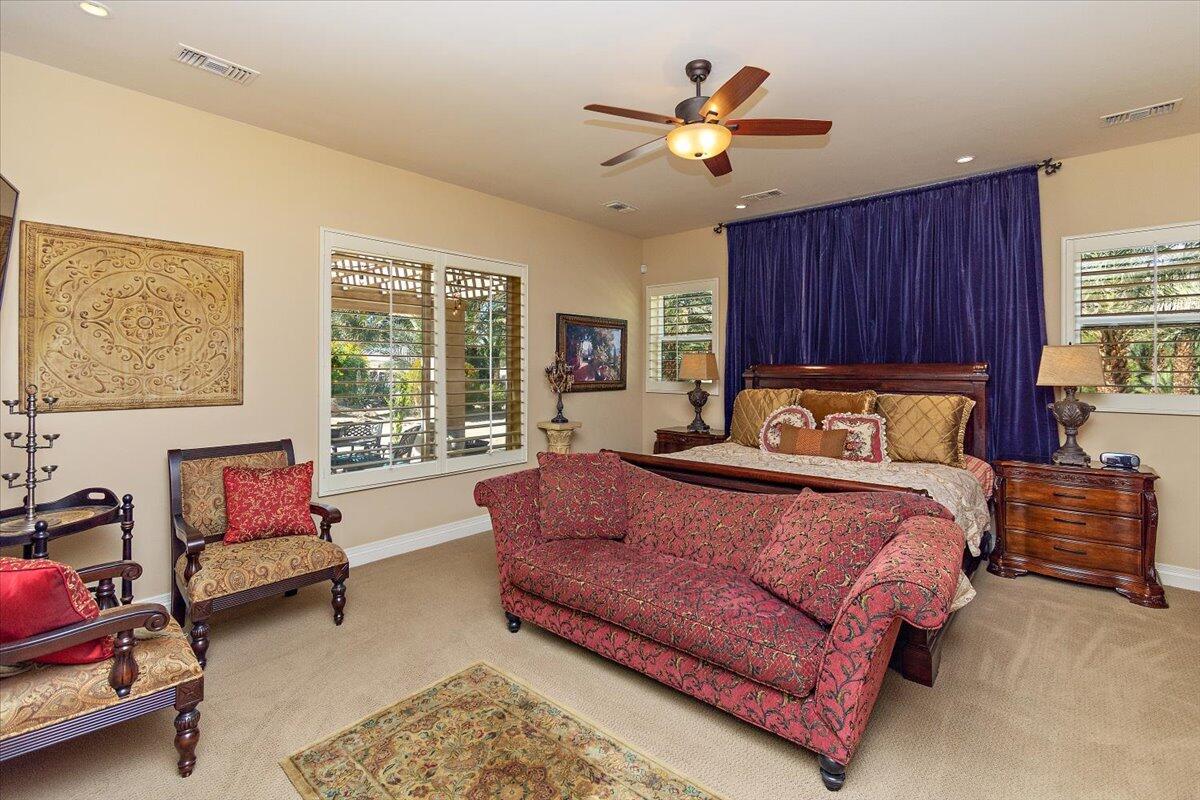 31453 Chimayo Road Thousand Palms, CA 92276 - Photo 17 of 71 a bed room with a bed couch and a window