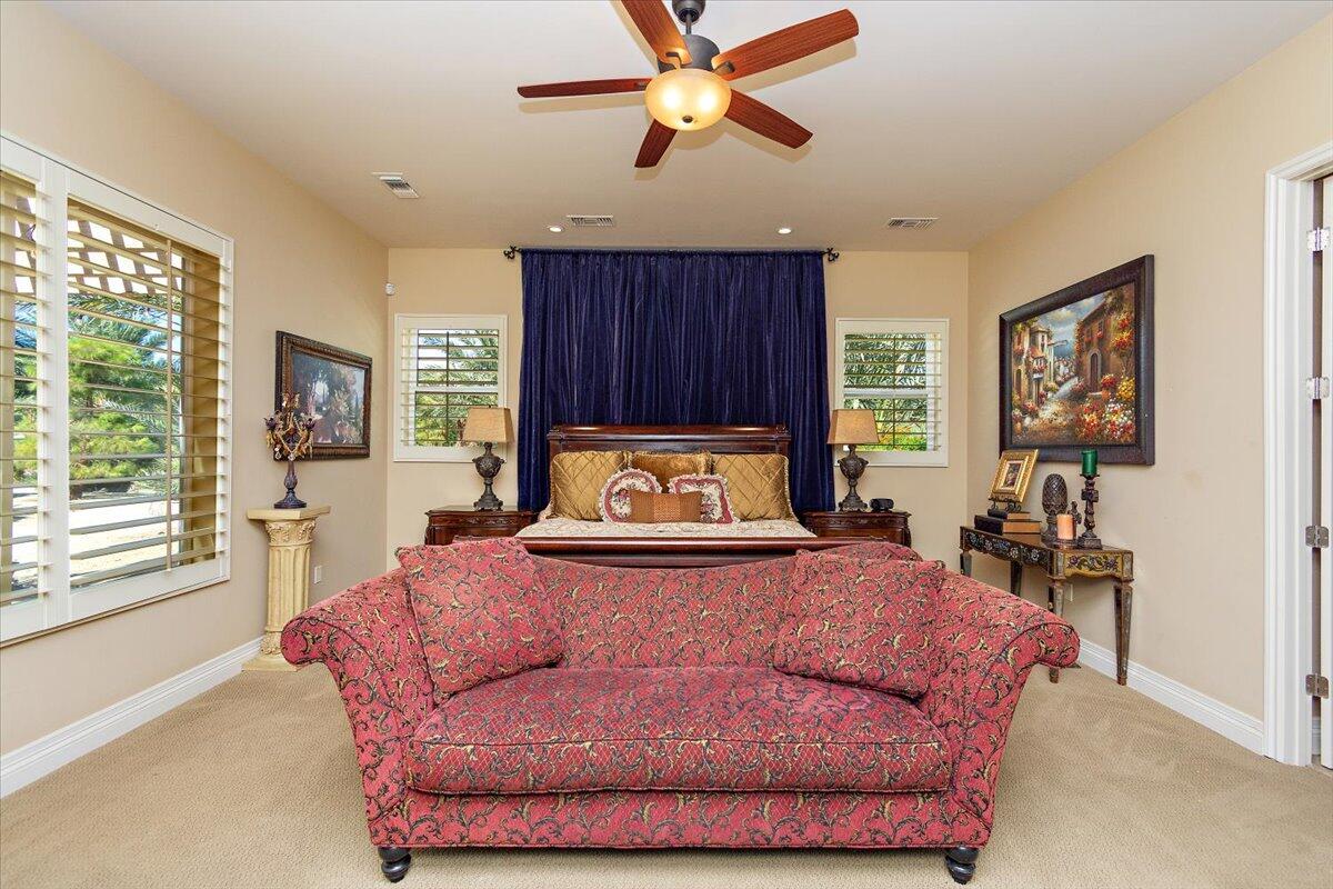 31453 Chimayo Road Thousand Palms, CA 92276 - Photo 18 of 71 a spacious bedroom with a bed and window