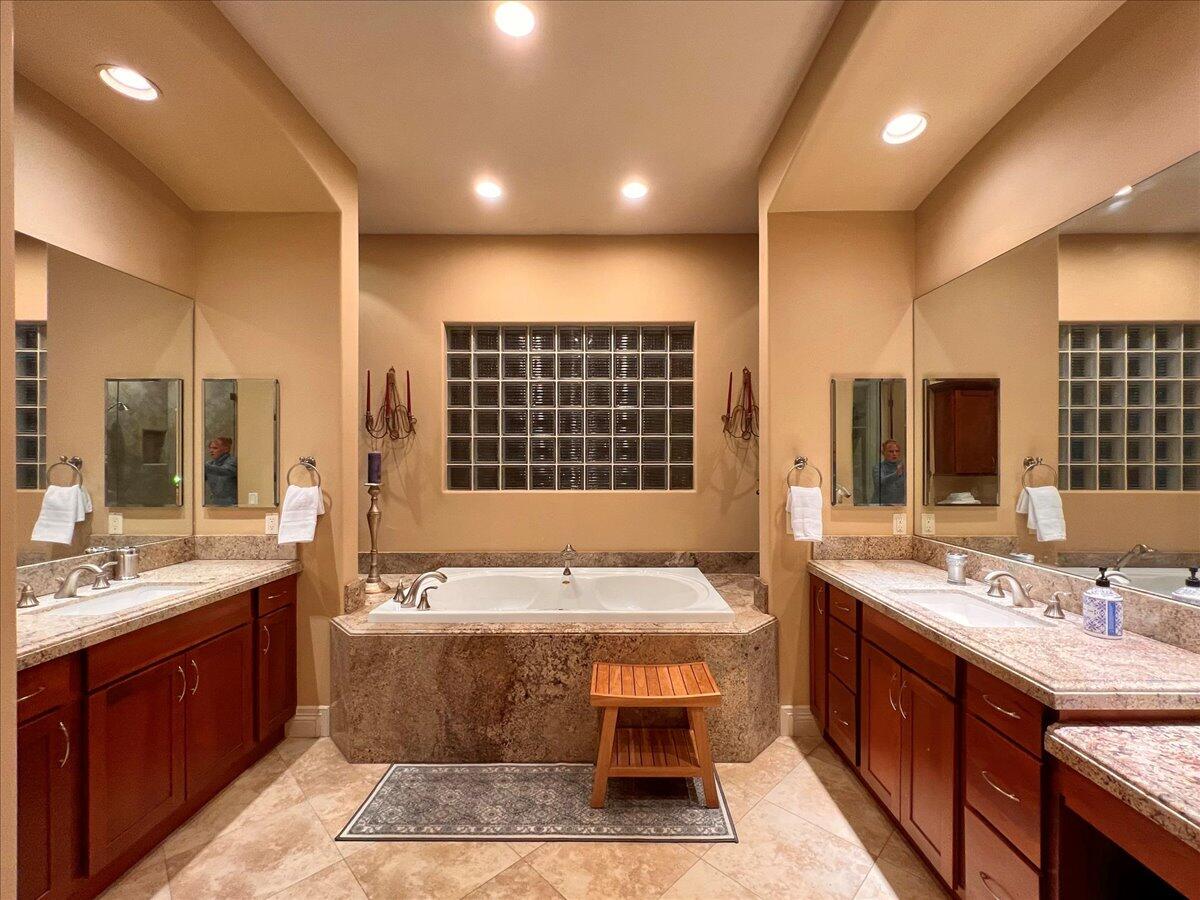 31453 Chimayo Road Thousand Palms, CA 92276 - Photo 20 of 71 a spacious bathroom with a double vanity sink large mirror and a bathtub