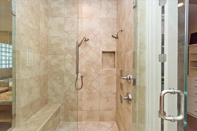 a bathroom with a toilet and a shower