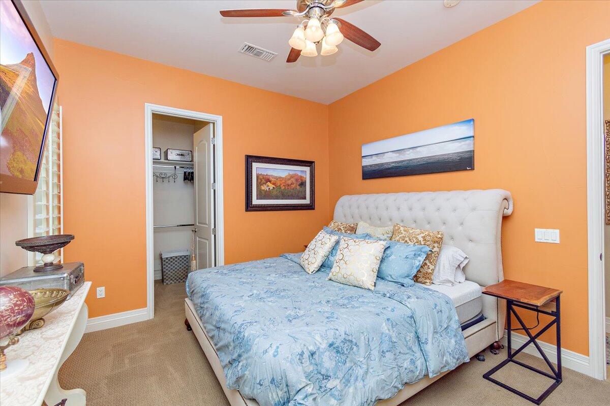 31453 Chimayo Road Thousand Palms, CA 92276 - Photo 30 of 71 a bedroom with a bed and a chandelier