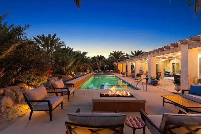 swimming pool view with a seating space