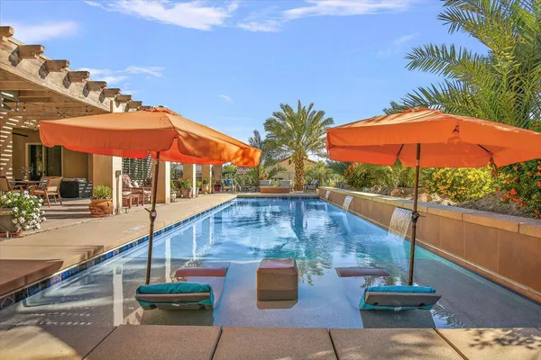 a view of a swimming pool with outdoor seating