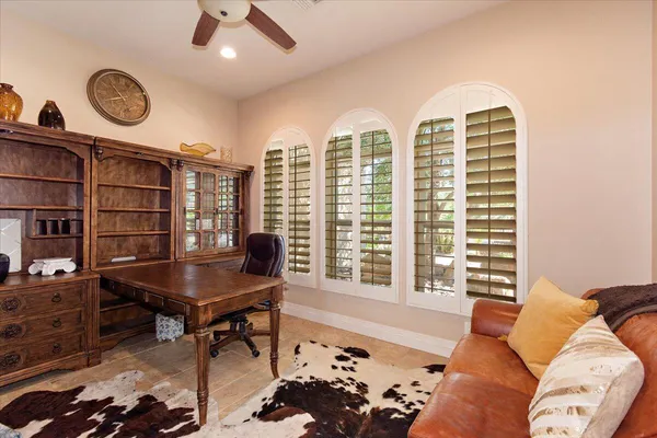 a view of a patio with couches table and chairs and potted plants